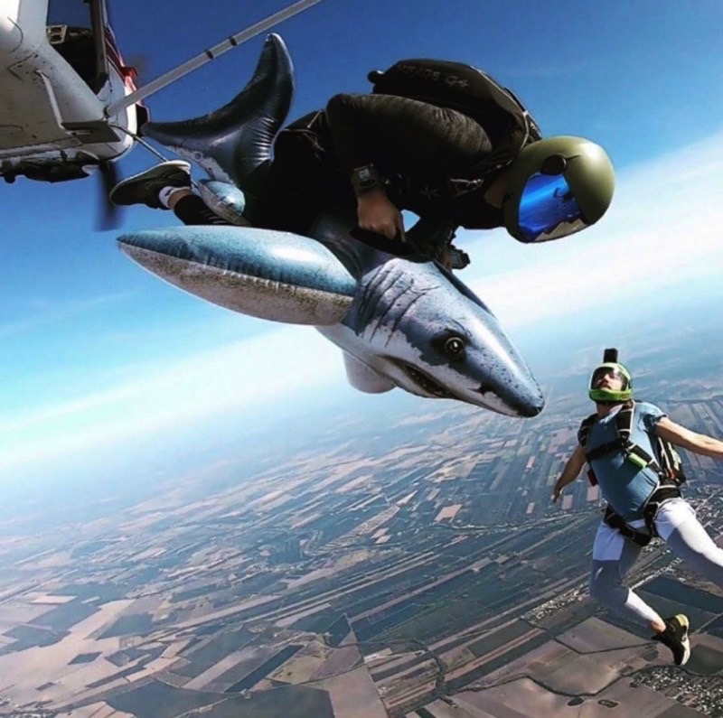 skydiver riding a shark inflatable